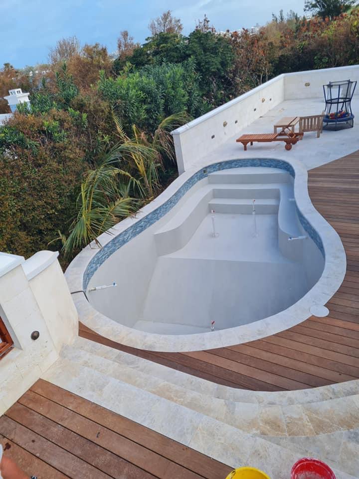 Unfilled Pool with wood and stone deck